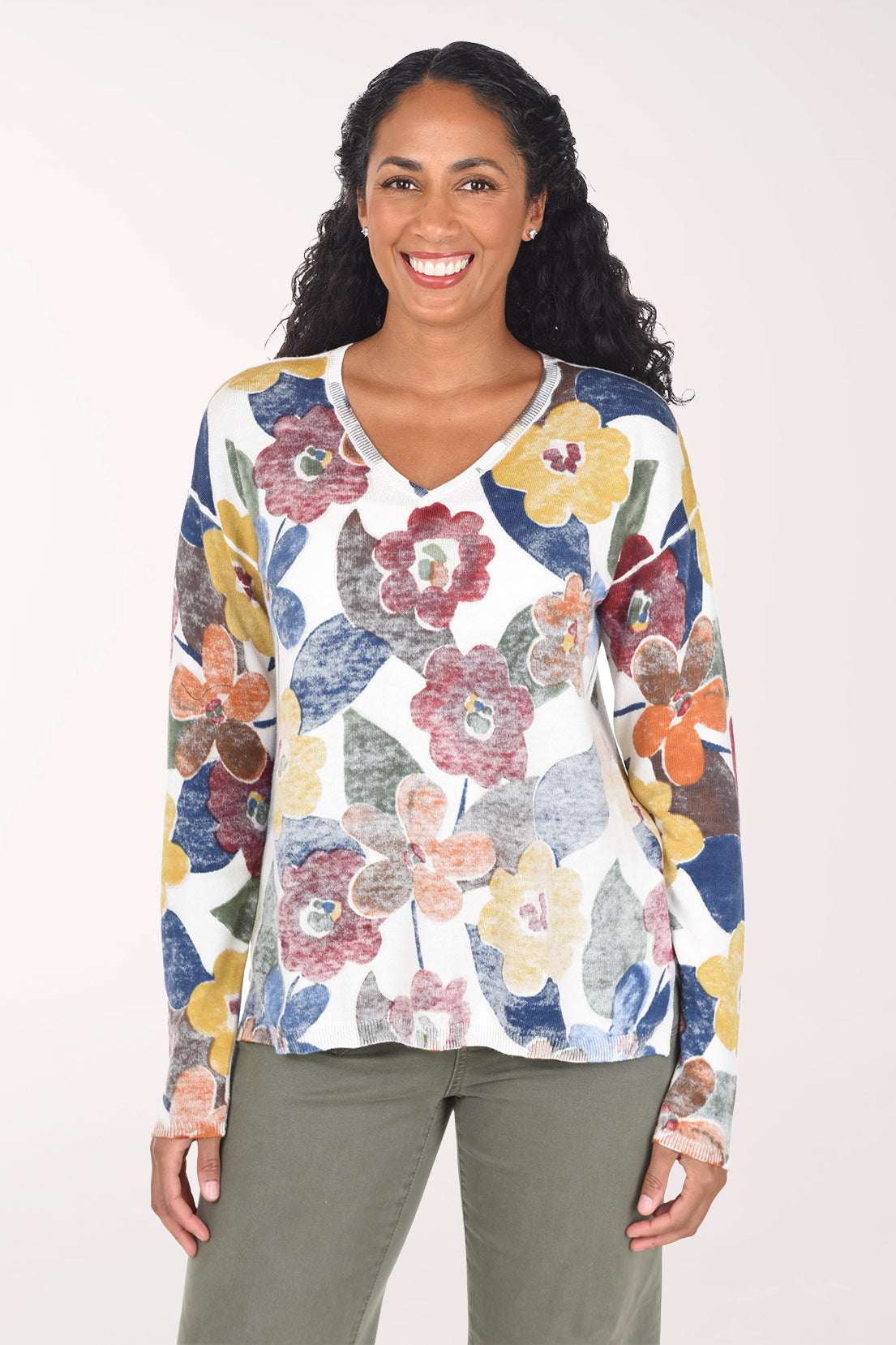 Woman wearing a long sleeve v-neck sweater with multi floral print