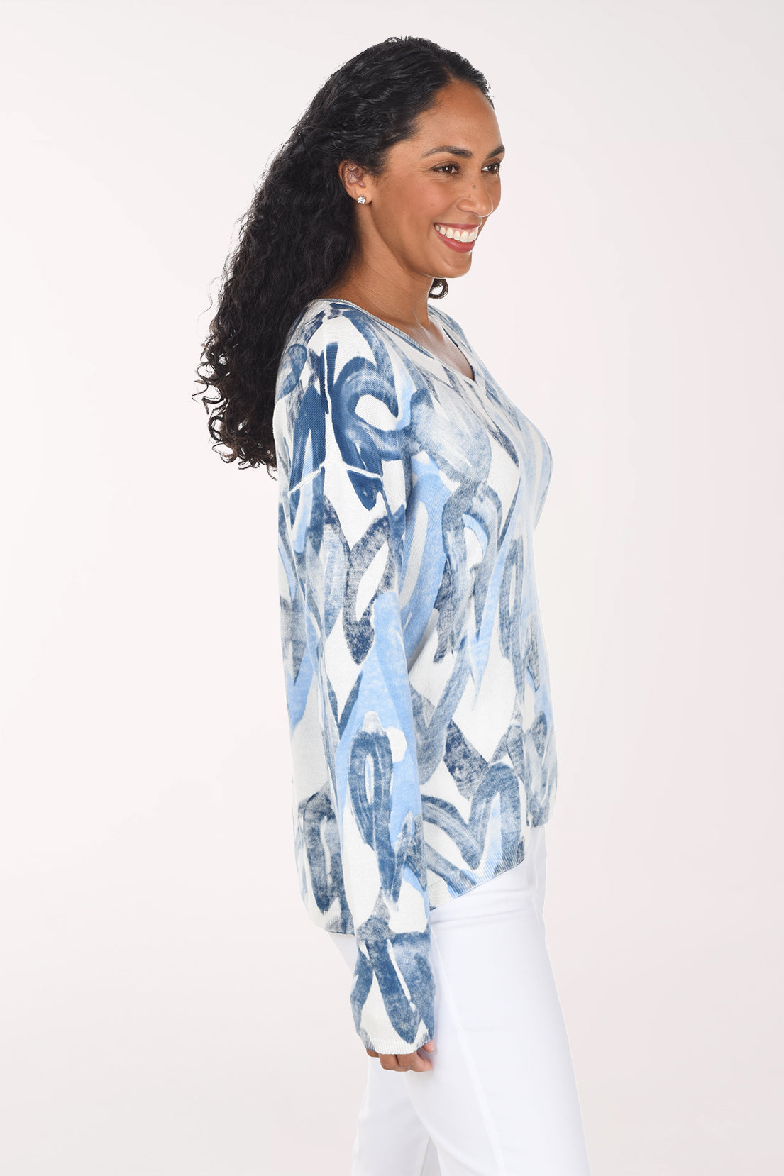 Woman wearing a long sleeve v-neck sweater with blue heart print