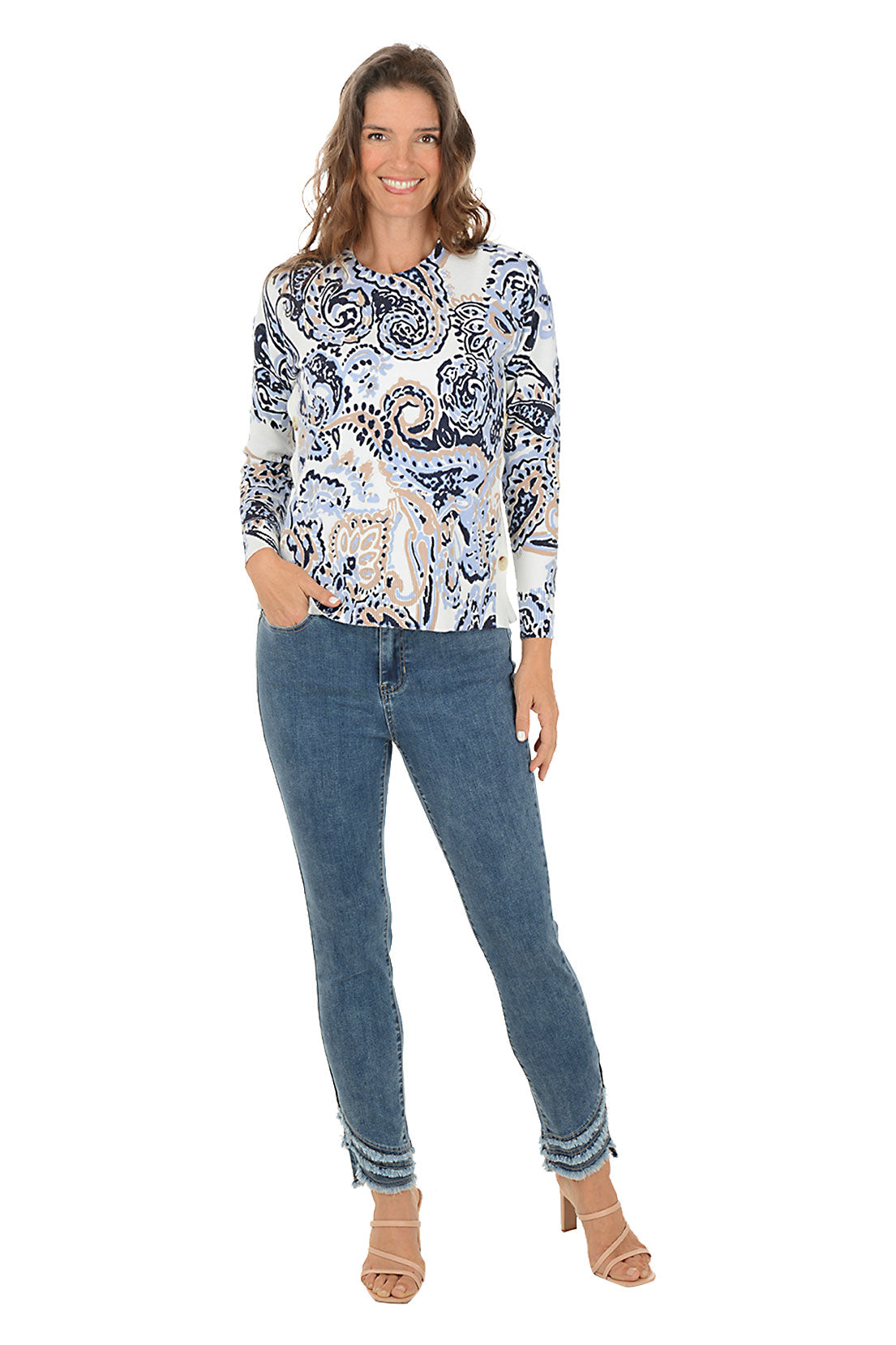A woman wearing a blue denim ankle pant with three tiers of fringe on the hemline. Full front shot.