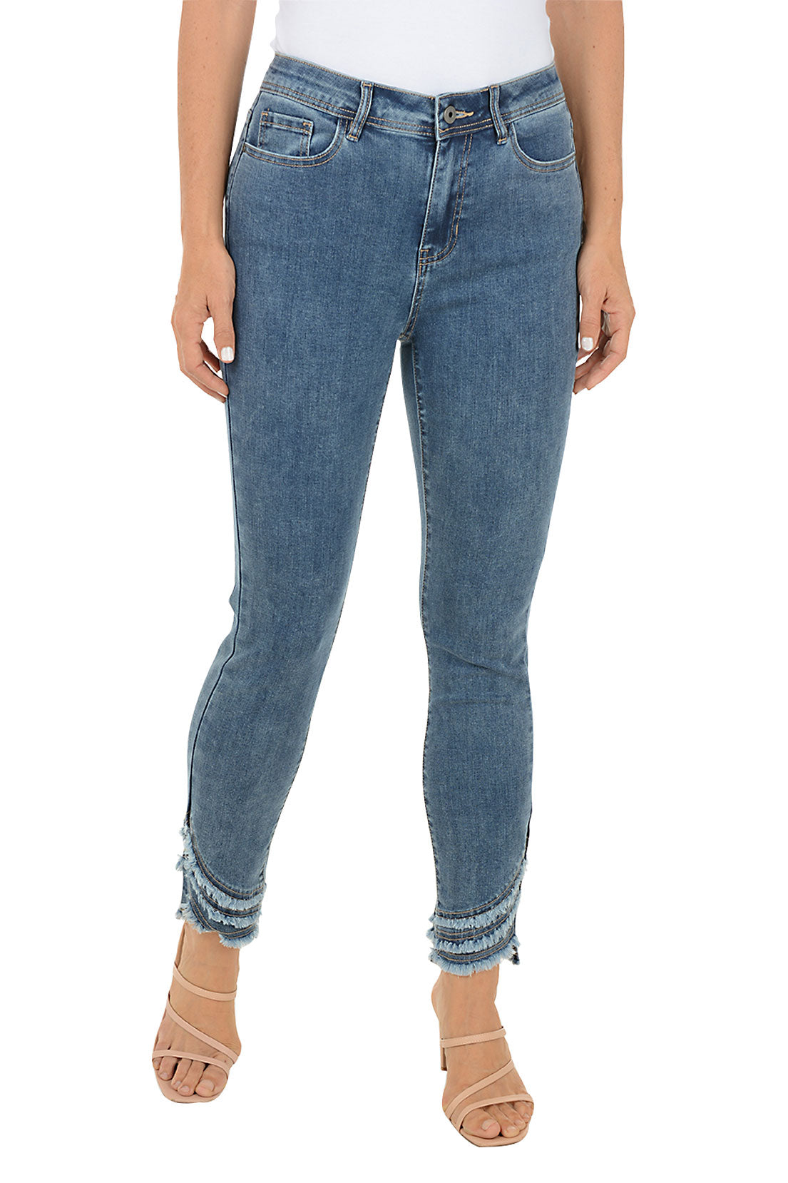 A woman wearing a blue denim ankle pant with three tiers of fringe on the hemline.