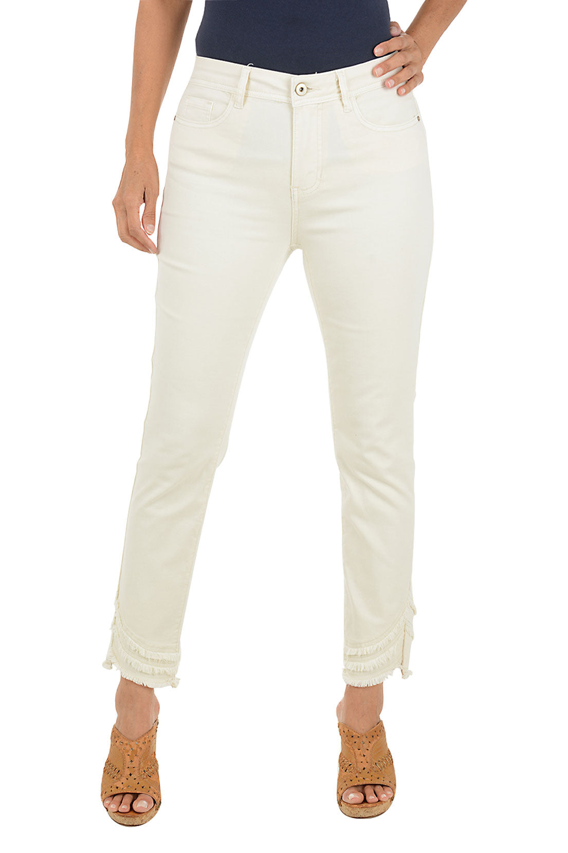 A woman wearing a beige ankle pant with three tiers of fringe on the hemline.