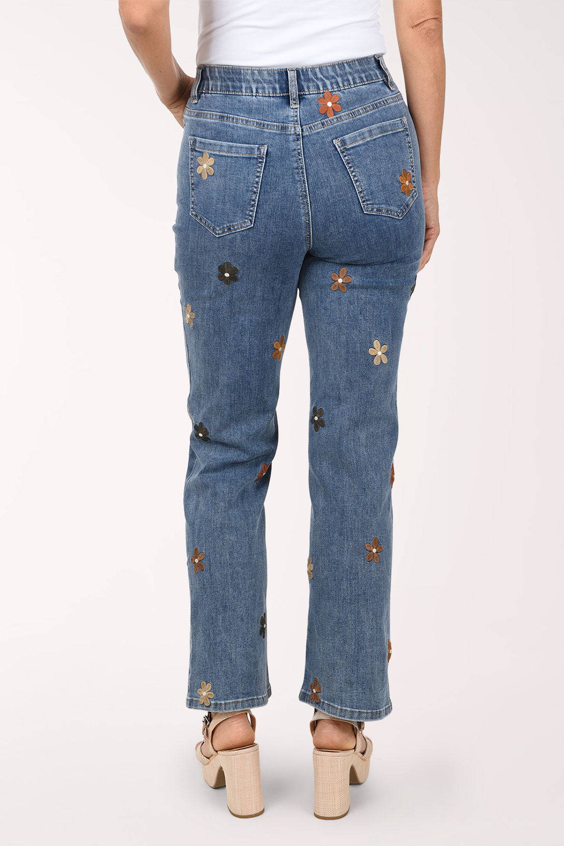 A back view of the embroidered flower straight leg jeans showing flowers on the back of the legs.