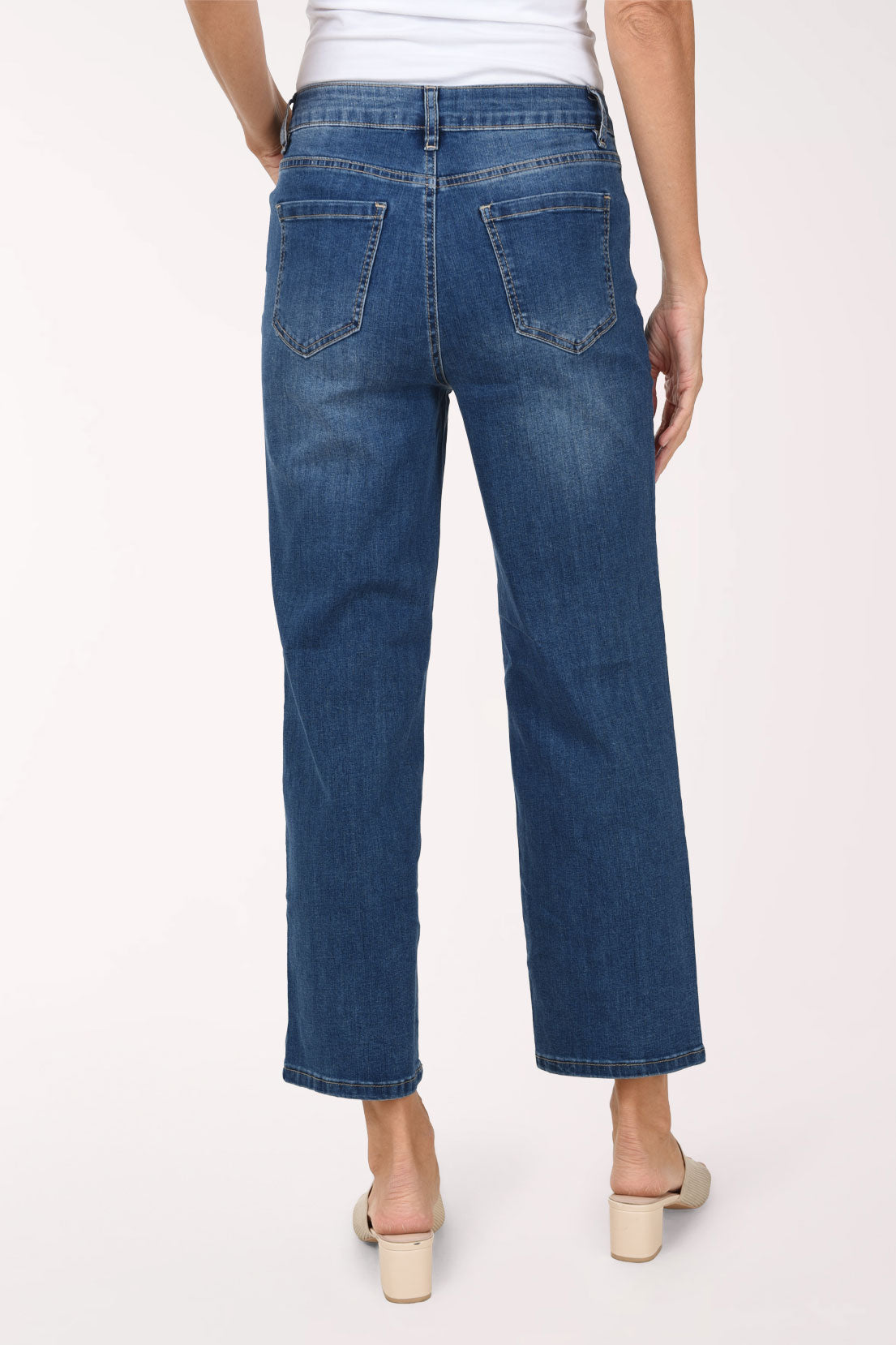 A back view of the medium wash straight leg jeans showing the back pockets.