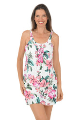 Woman wearing a white multi floral tankini top on a white background.