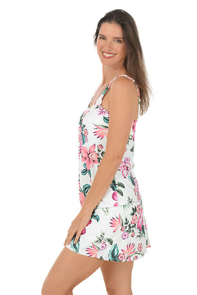 Woman wearing a white multi floral tankini top on a white background. Side shot.