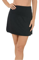 A woman wearing a black swim skort.