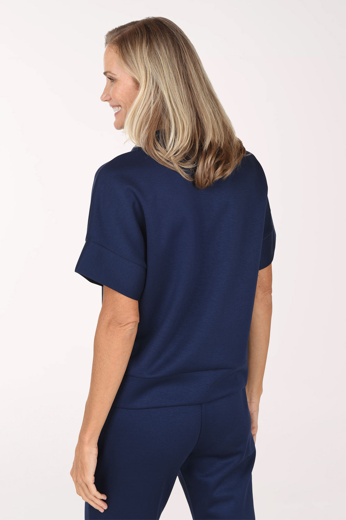 Back view of the navy Jet Blue scuba half zip top showing the collar, smooth back and straight hem.