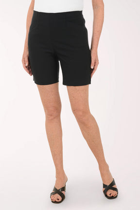 Person wearing black shorts on a white background