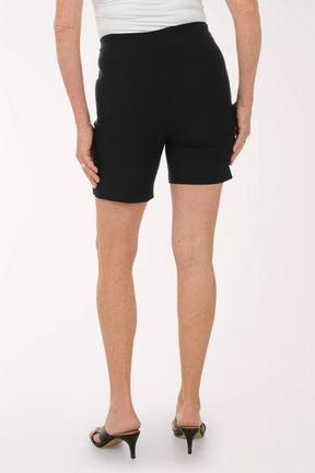 Person wearing black shorts on a white background