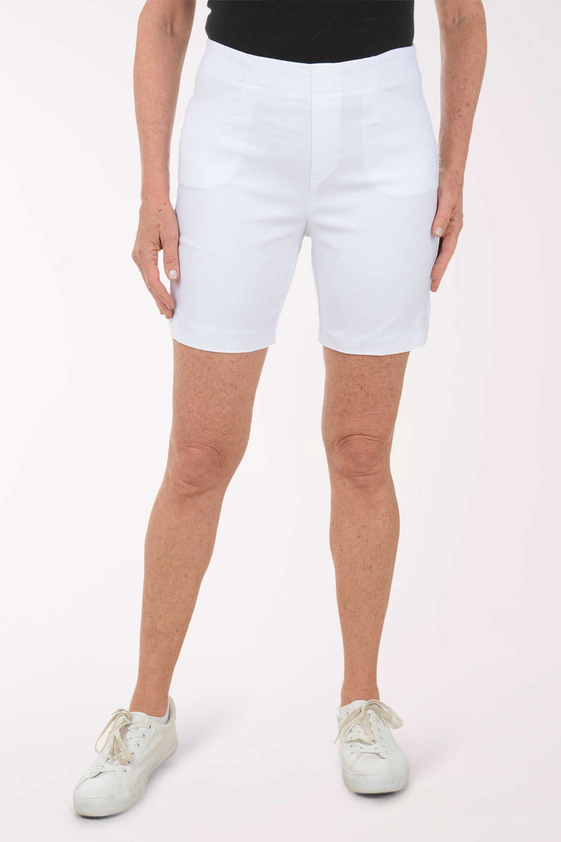 Person wearing white shorts on a white background