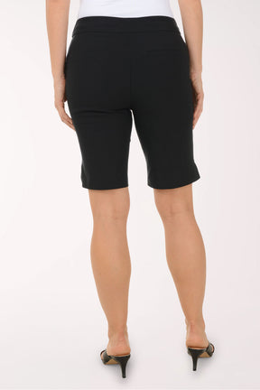 Person wearing black shorts on a white background