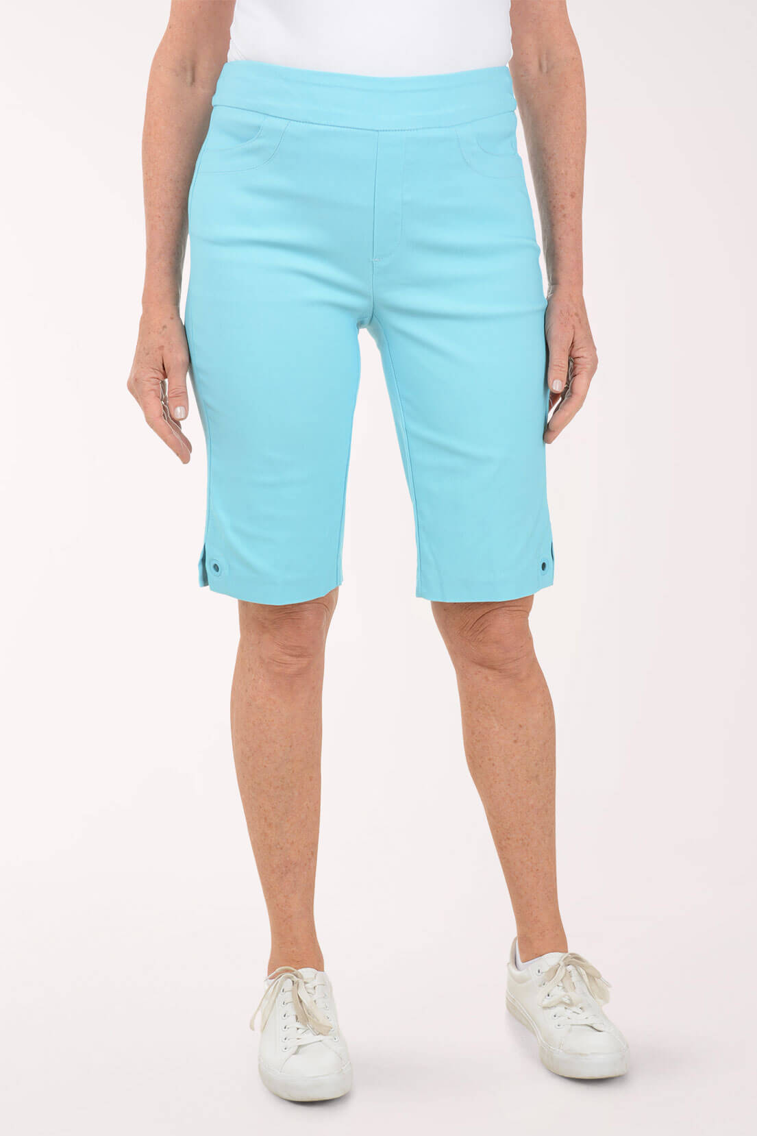 Person wearing light blue shorts on a white background