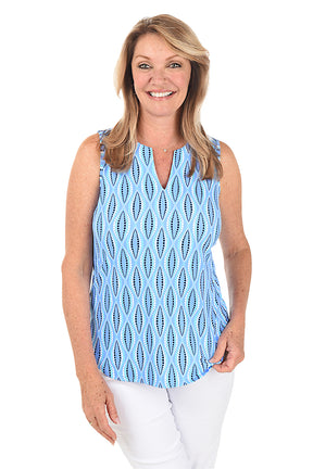 A woman wearing a sleeveless knit top with a split v-neckline and curved hemline, in a blue and white geometric pattern.