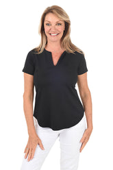 A woman wearing a black split v-neck tee with short sleeves and standing in front of a white background.