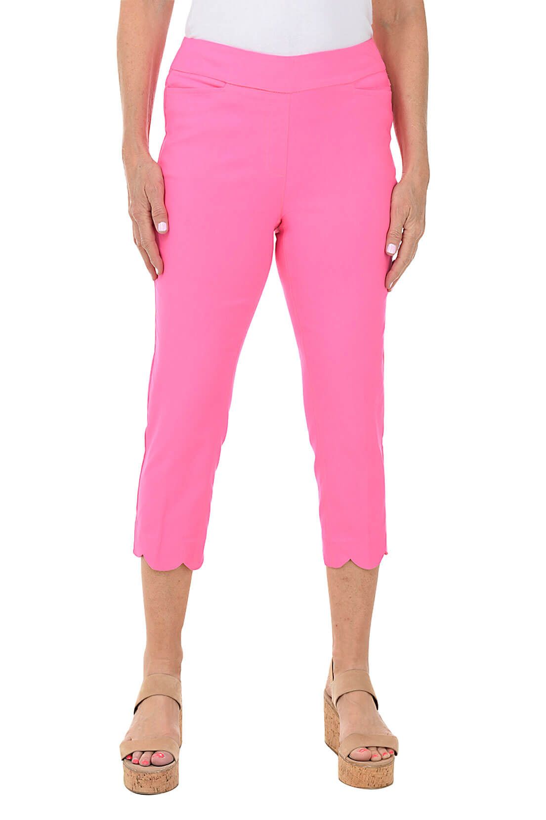 Pink capri pants worn by a person on a white background