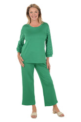 Woman wearing a green outfit with a white background