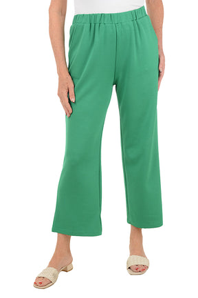 Green pants worn by a person on a white background.