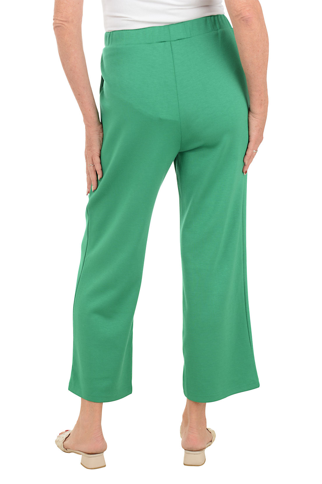 Green pants worn by a person on a white background. Back shot.