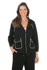 Woman wearing a black hoodie with white accents on a white background.