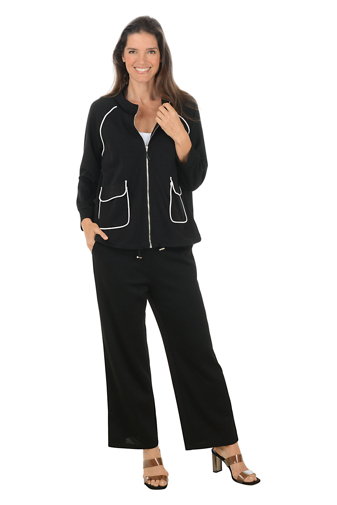 Woman wearing a black outfit with white piping on a white background.