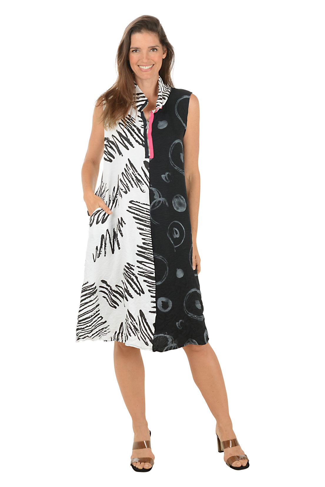 Woman wearing a sleeveless dress with black and white abstract pattern on a white background