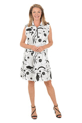 Woman wearing a sleeveless dress with black abstract pattern on a white background