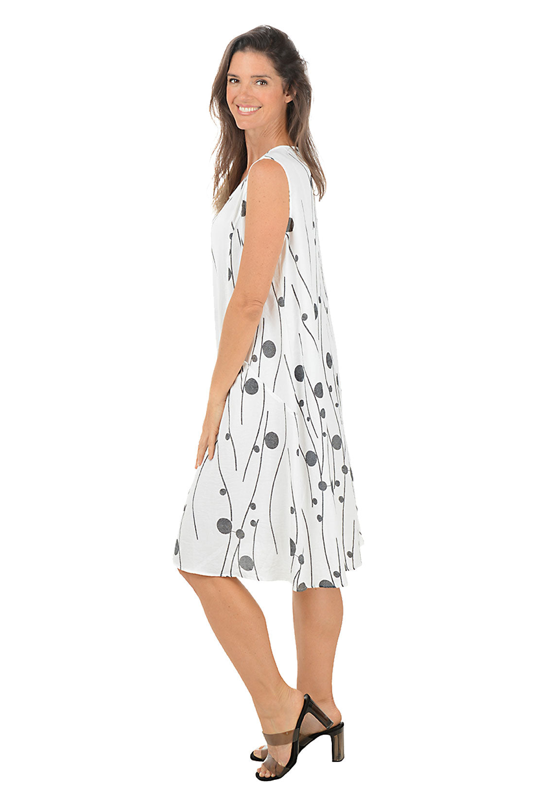 Woman wearing a white dress with black patterns on a white background