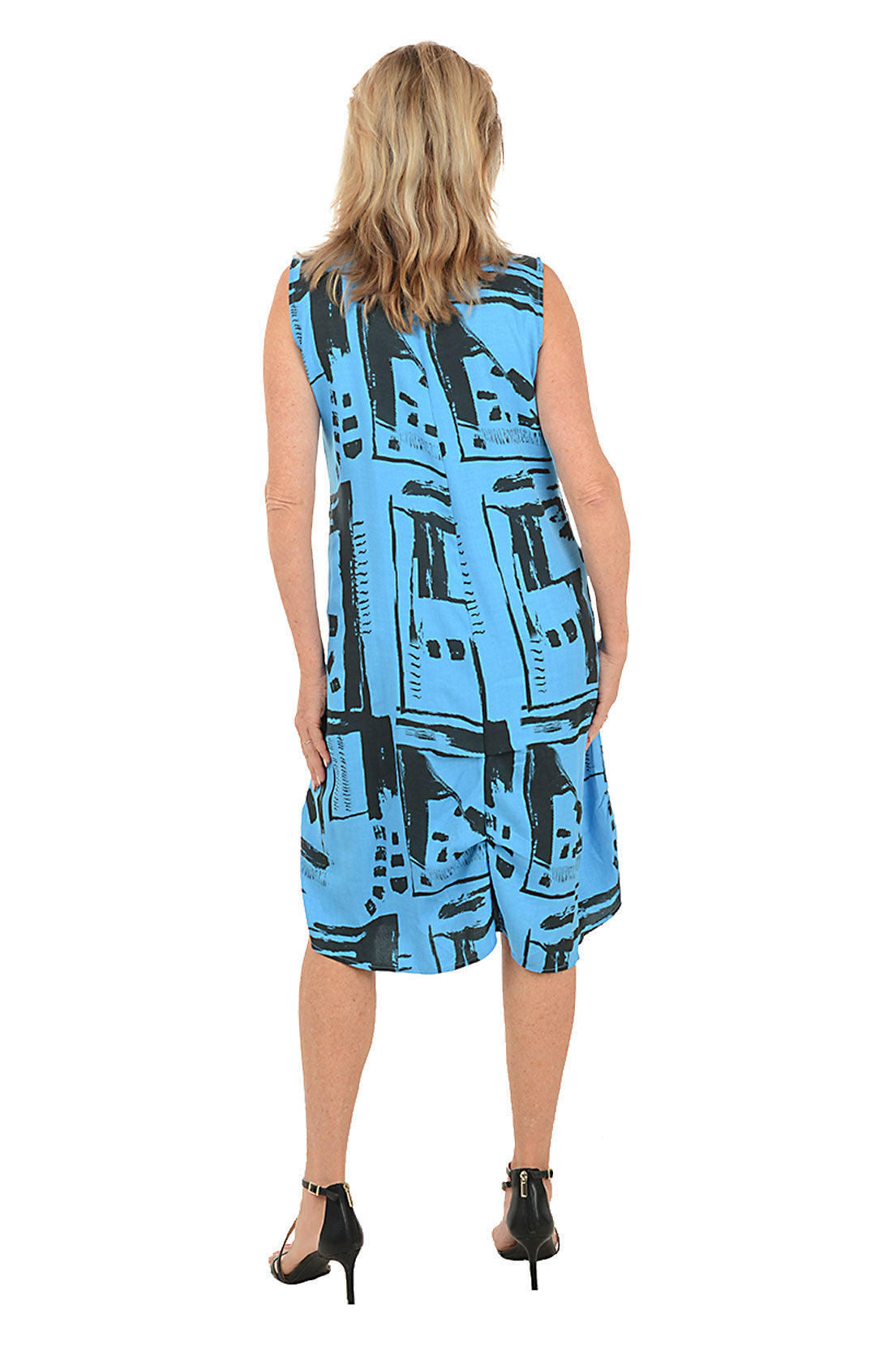 Woman wearing a blue patterned dress on a white background