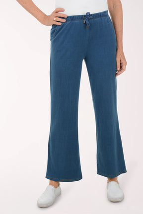 Person wearing blue pants on a white background