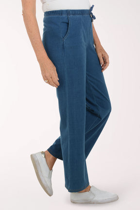 Person wearing blue pants on a white background