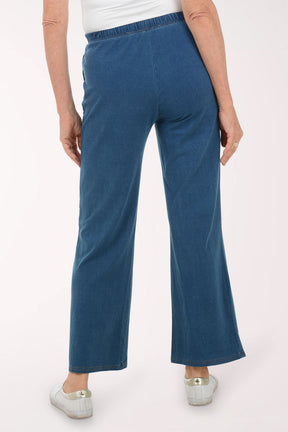 Person wearing blue pants on a white background