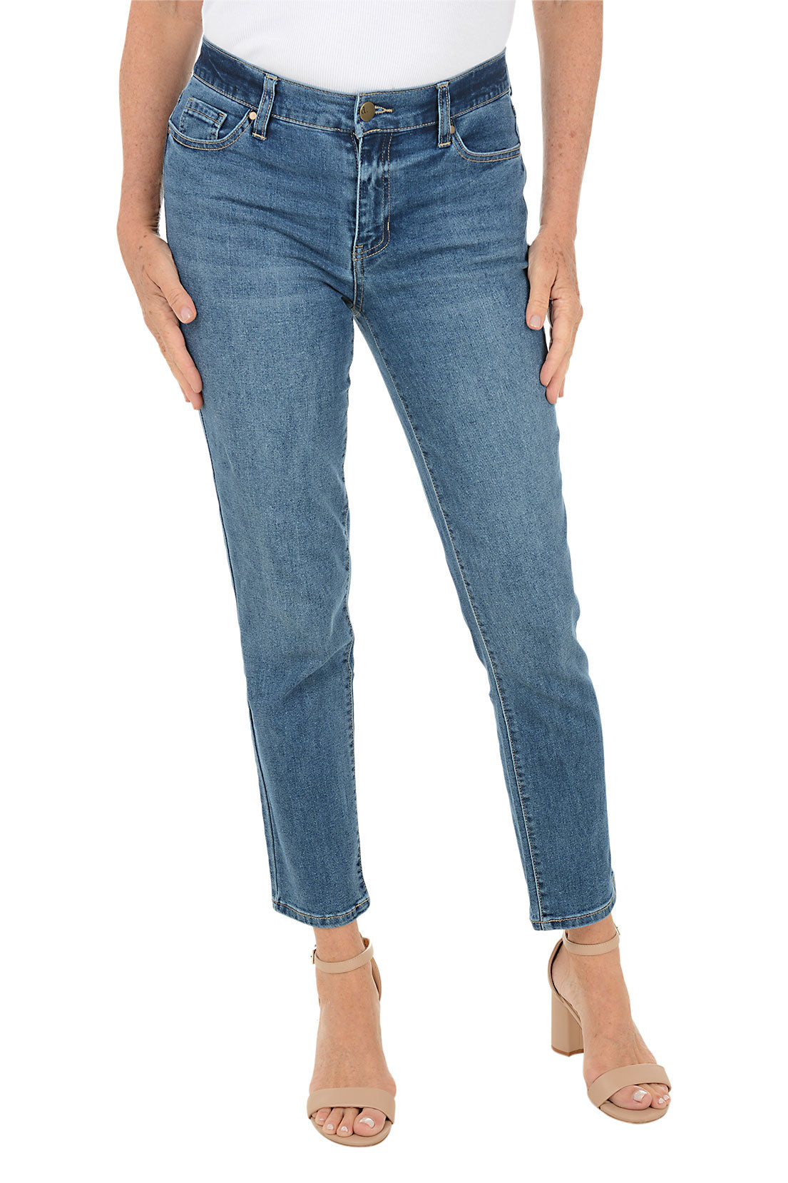Blue denim ankle jeans worn by a person on a white background.