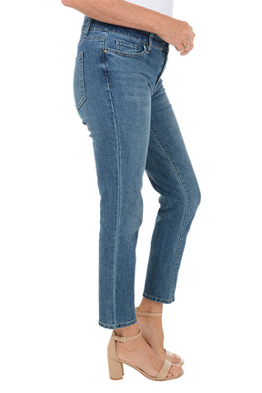 Blue denim ankle jeans worn by a person on a white background. Side shot.