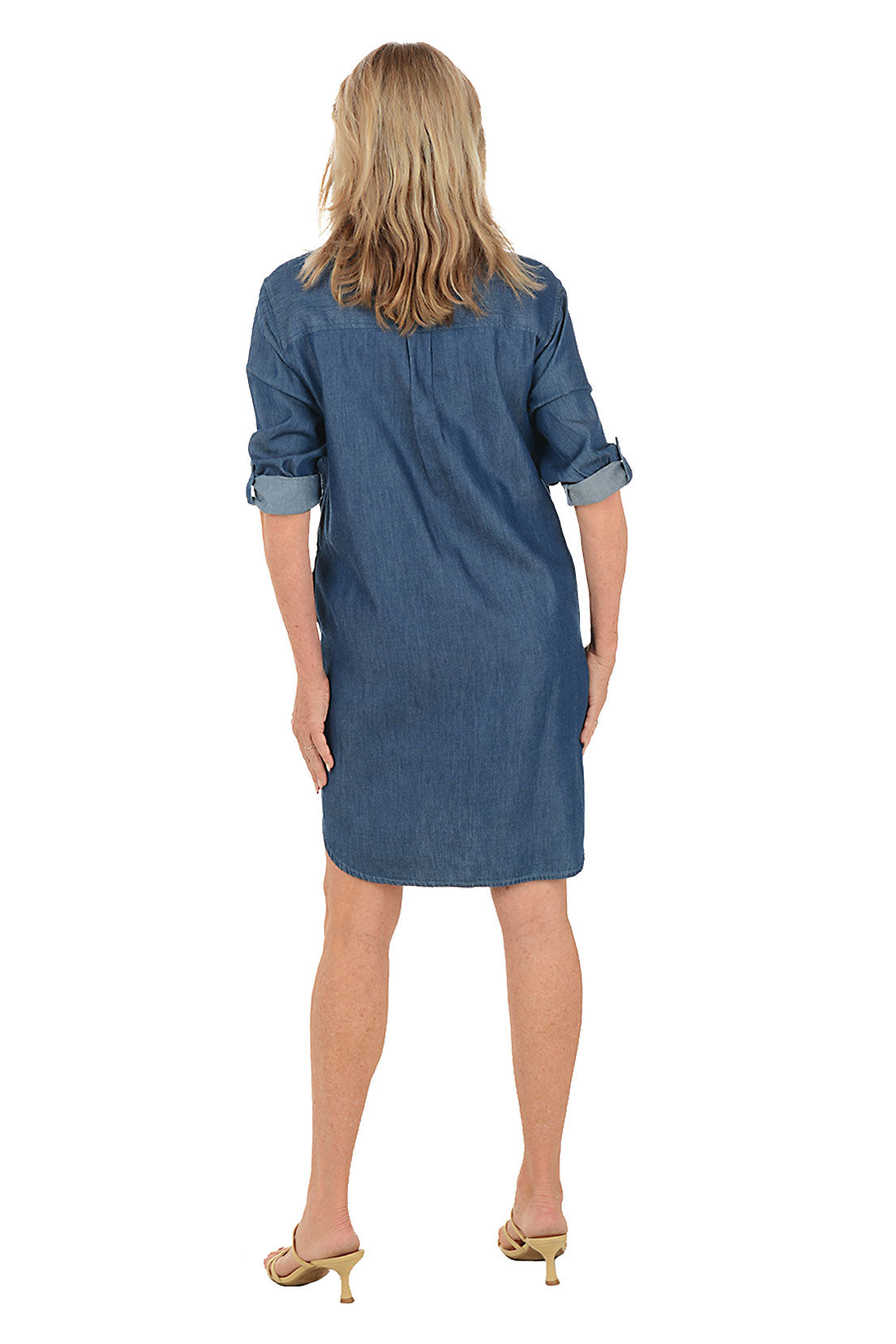 Woman wearing a blue denim dress on a white background