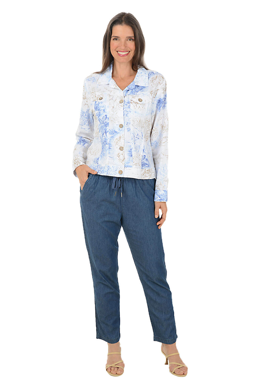 Woman wearing a floral shirt and blue pants on a white background