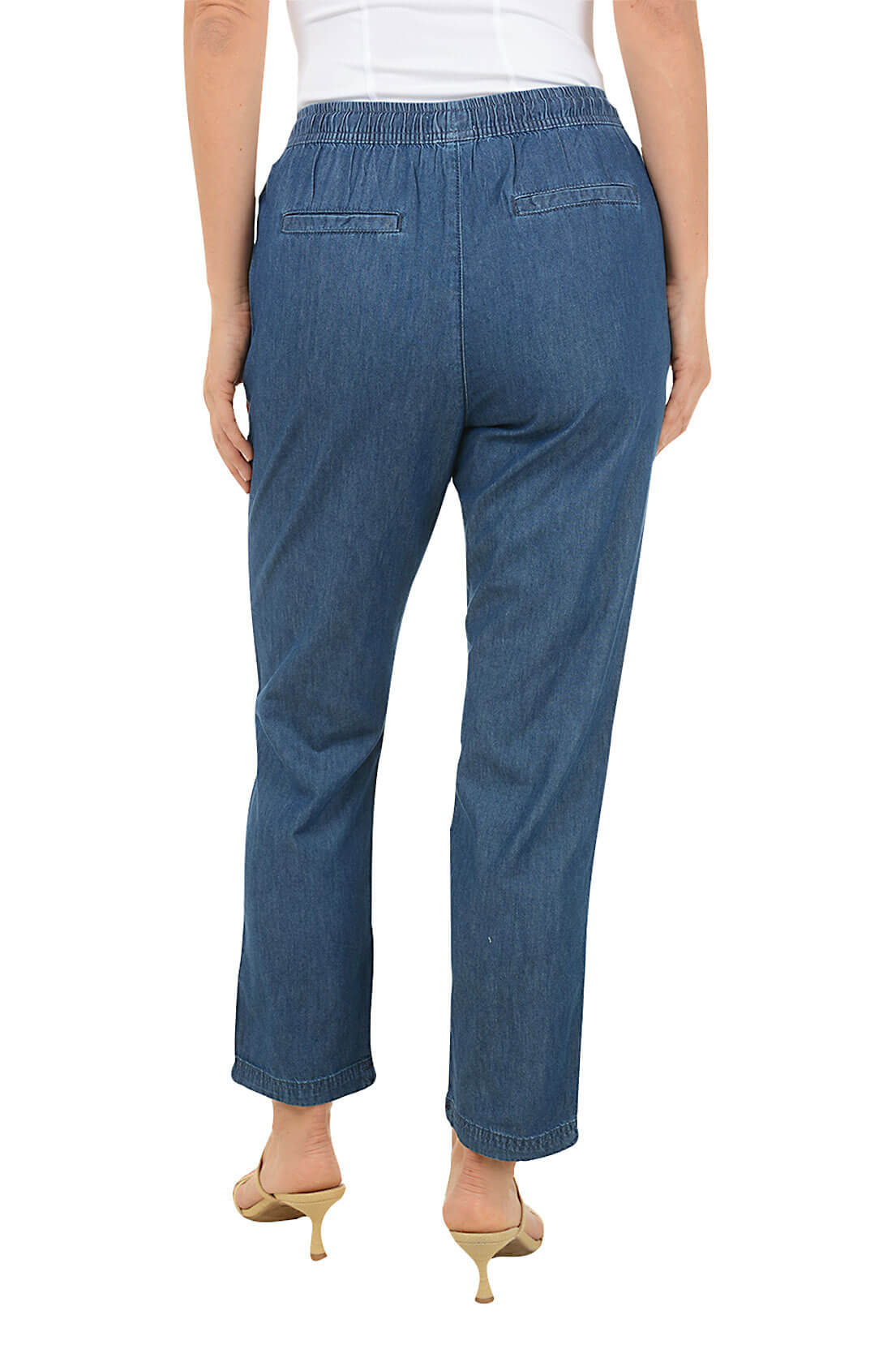 Blue jeans worn by a person on a white background. Back shot.
