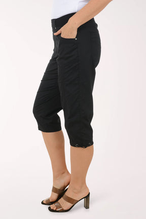 Woman wearing solid black capri pants.