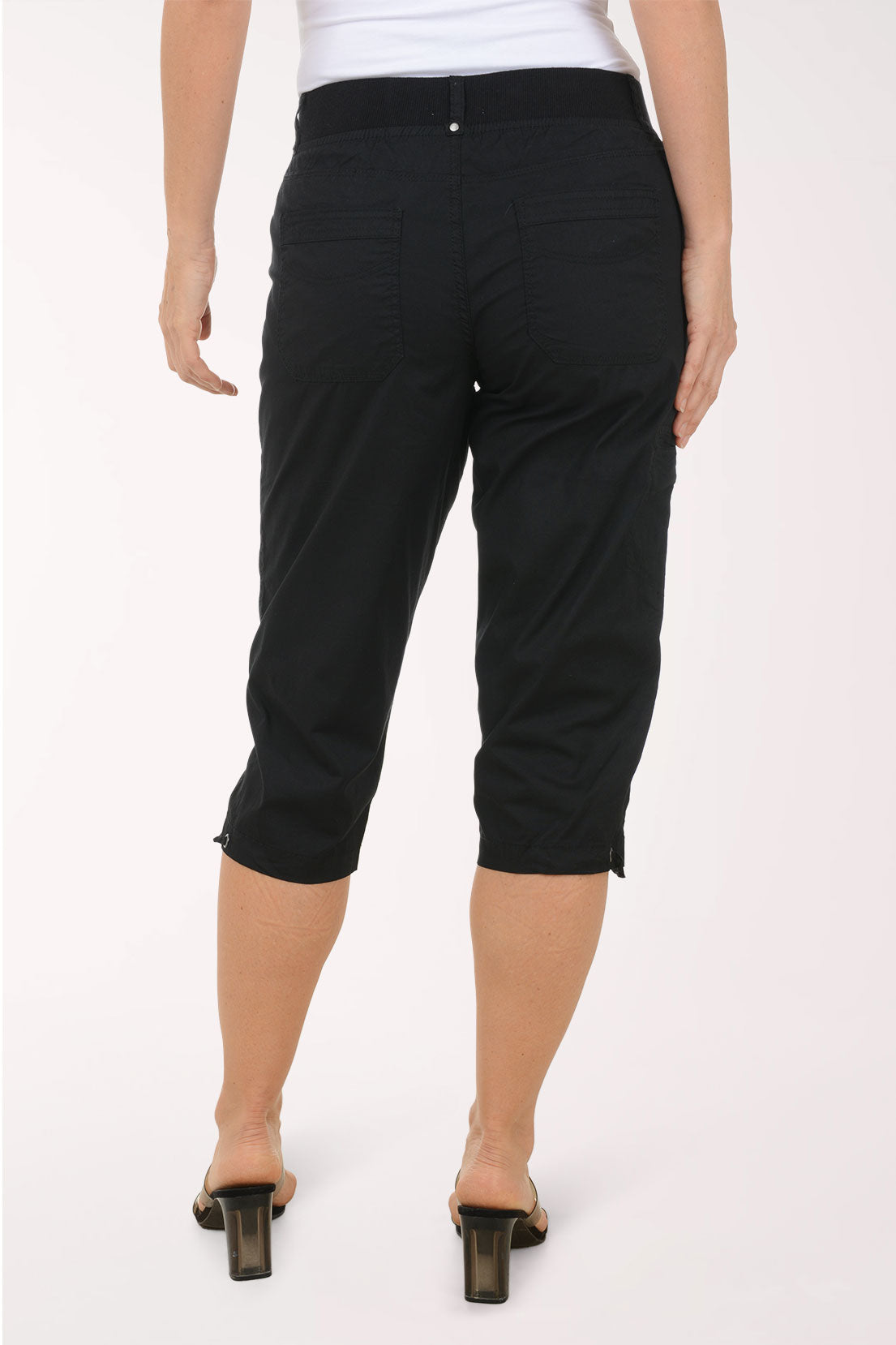 Woman wearing solid black capri pants.