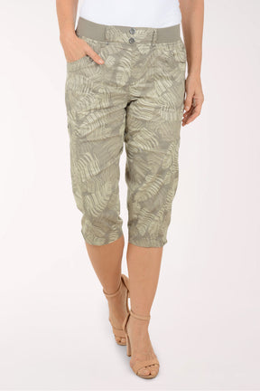 Woman wearing green leaf printed capri pants.