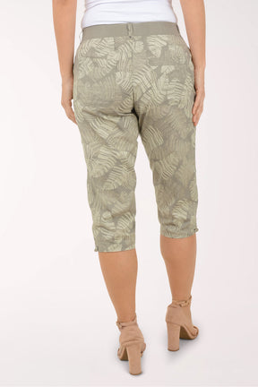 Woman wearing green leaf printed capri pants.