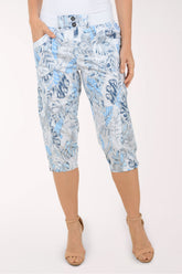Woman wearing blue and white leaf printed capri pants.