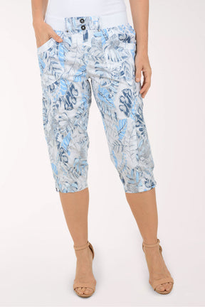 Woman wearing blue and white leaf printed capri pants.