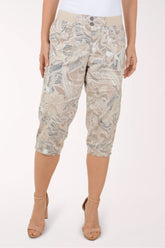Woman wearing brown and grey leaf printed capri pants.