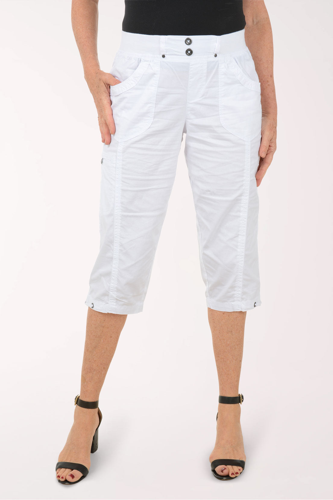 Woman wearing solid white capri pants.