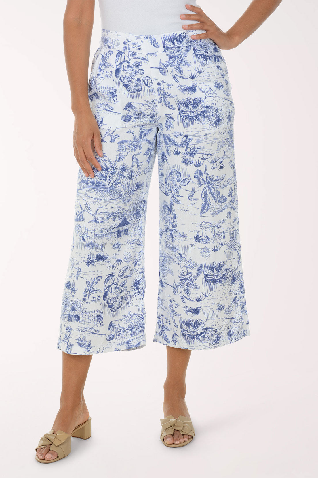Person wearing blue floral print pants on a white background