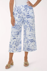 Person wearing blue floral print pants on a white background