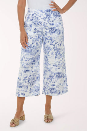 Person wearing blue floral print pants on a white background