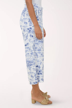 Person wearing blue floral print pants on a white background