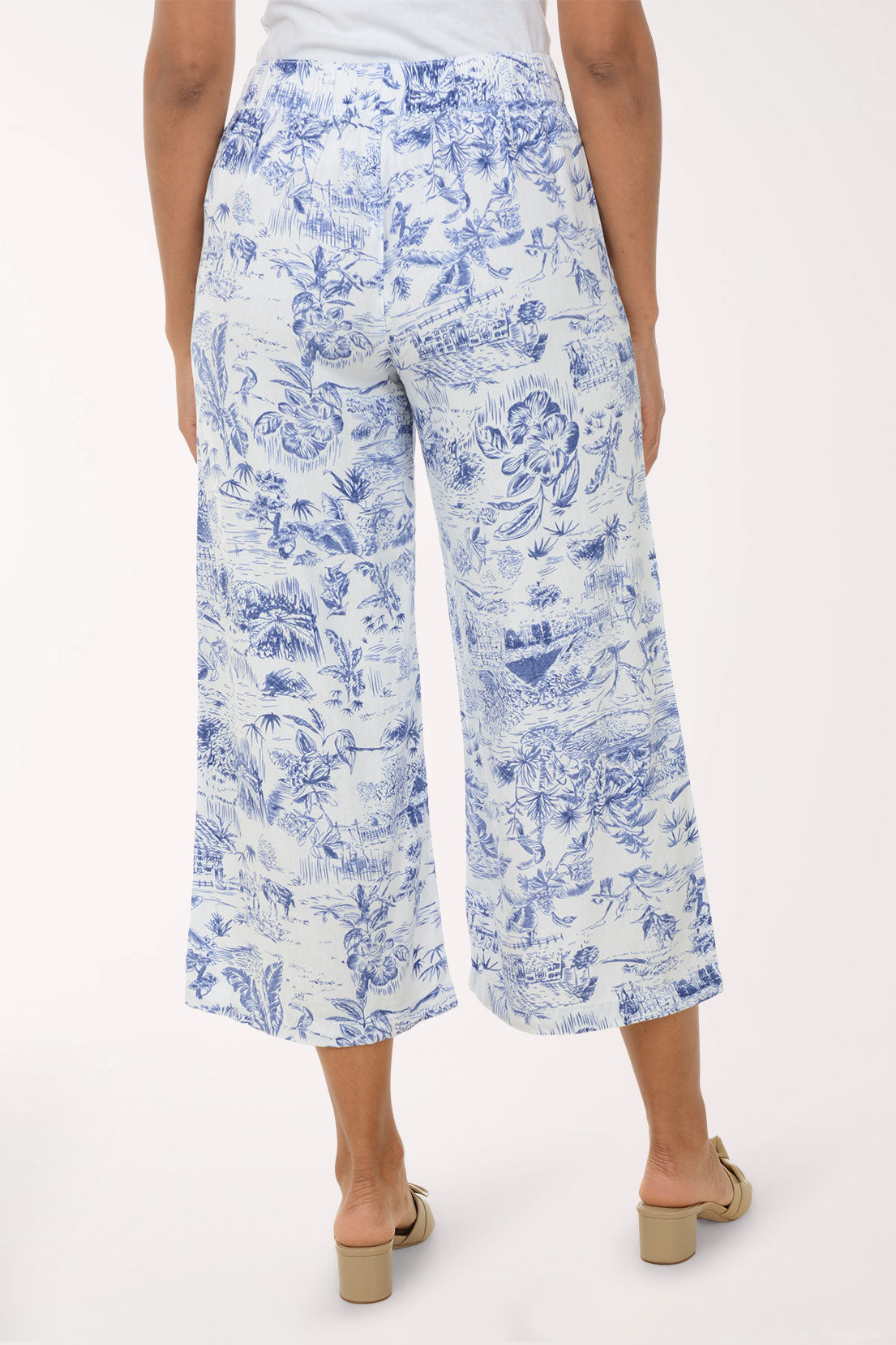 Person wearing blue floral print pants on a white background