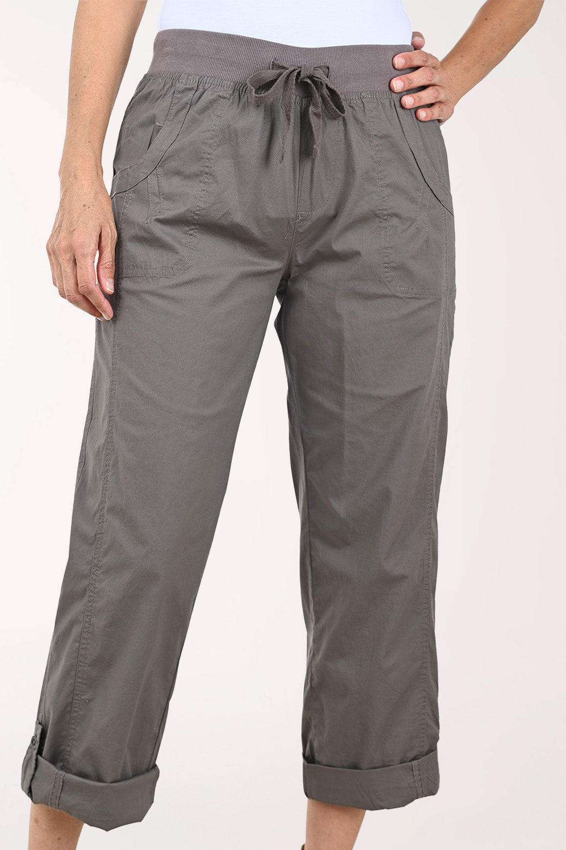 A person wearing dark gray drawstring cropped pants with rolled cuffs, shown from the waist down against a plain light background.